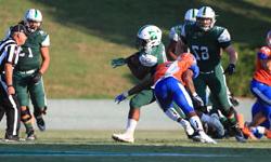 A Stetson University football running back avoid a tackle while running the ball.